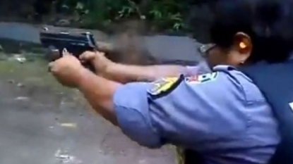 Policewoman tries to fire a gun but instead gets hit on her own face